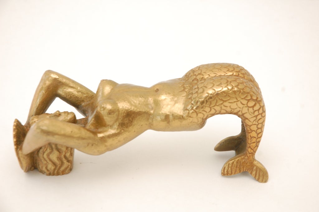 A stylized cast bronze mermaid door pull by Vadim Androusov. Mounts with two bolts behind the head and tail.  Androusov collaborated with Andre Arbus creating unique bronze hardware and mounts for his furniture.