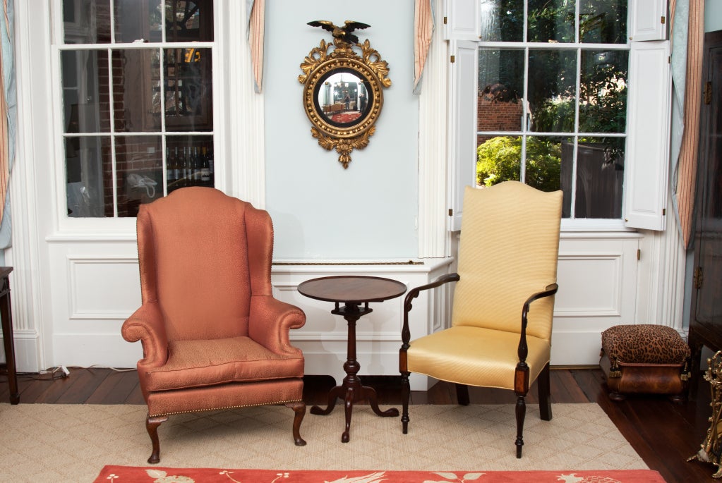 This high style wing chair has a stepped back, rolled arms, and cabriole legs with pad front feet that are indicative of the work of a master cabinet maker. The patina of the legs is beautiful -- the chair is strong and comfortable.