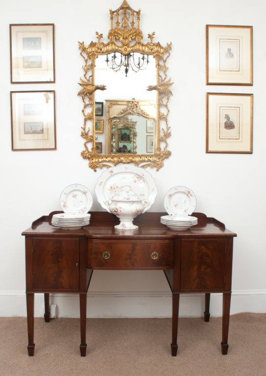 This incredibly beautiful and magnificently carved Chinese Chippendale mirror represents the apex of rococo English design. The open-carved sides, with 3-dimensional birds taking flight, are each carved from a single piece of wood - as is the