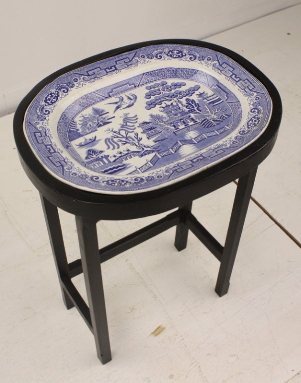 Antique blue willow platter from England on a custom built black stand.  Many uses, but perfect as an end table or side table. The Victorian blue willow platter is very very good. Makes a charming small coffee table. Reduced.