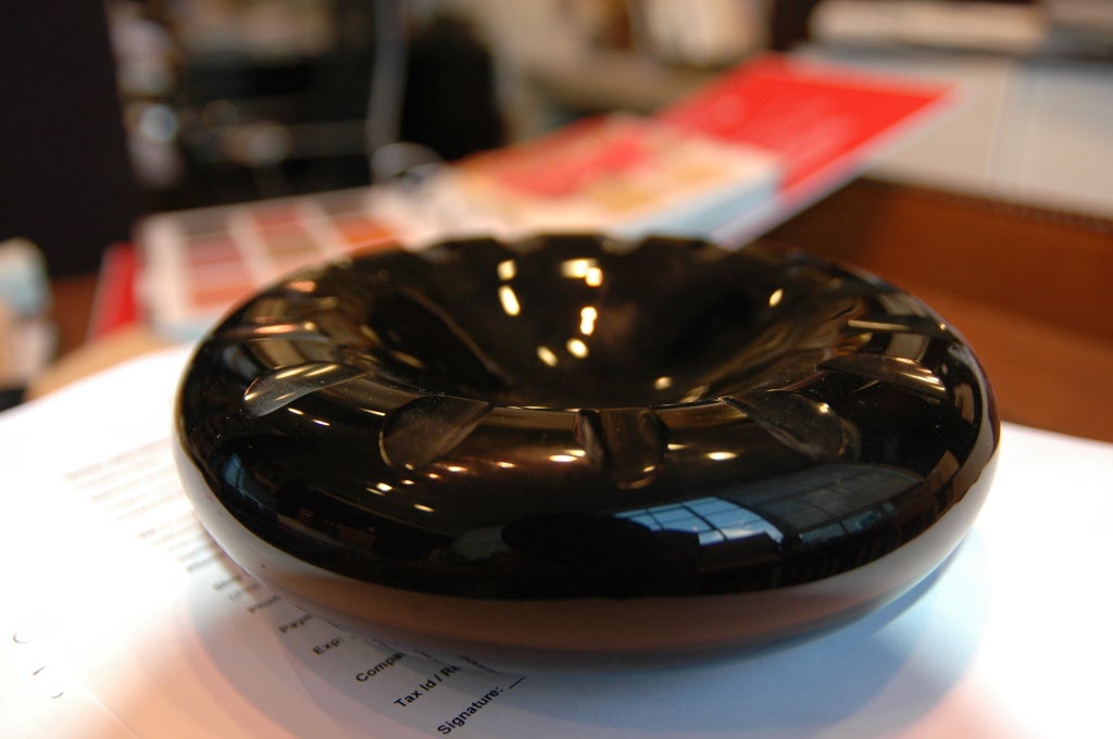 A black glass ashtray with good size and heft. Signed 