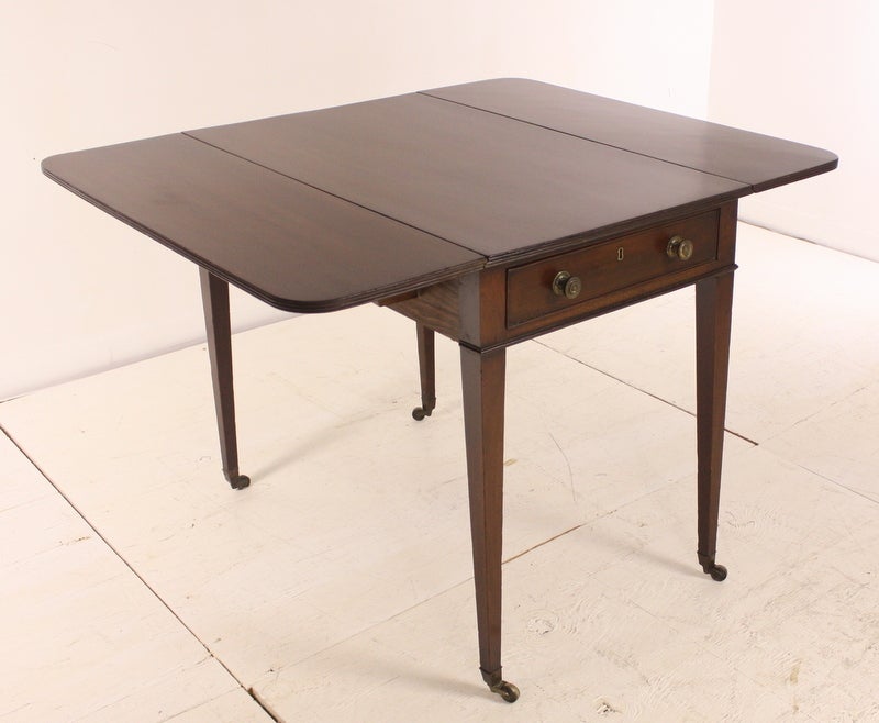 Georgian mahogany pembroke table. Elegant slender legs, reeded edges on the tabletop and cockbeading on the drawer fronts. There is one real drawer and one nonworking drawer as is typical of Pembroke tables. Open, the farm table measures 41
