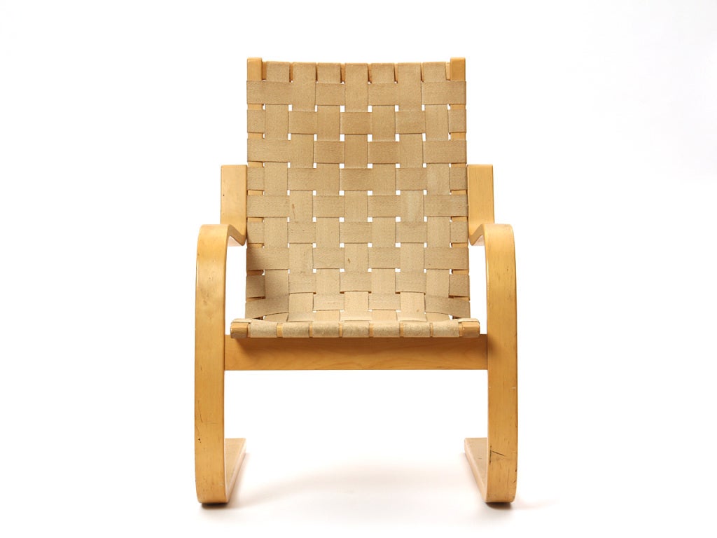 A Scandinavian Modern high-back armchair by Alvar Aalto in an iconic bent birch frame with the original woven web upholstery. Made by Artek in Finland, circa 1930s.