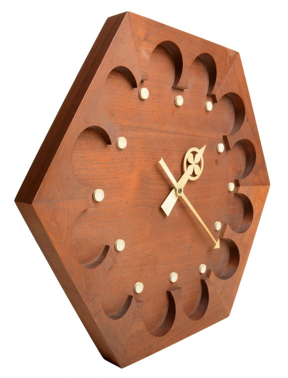 A rare large example.  George Nelson and Associates designed numerous clocks for Howard Miller in the 1940 through to the 1970's. This example by Nelson associate Arthur Umanoff. 
This example is solid walnut with enamelled hour markers and iconic