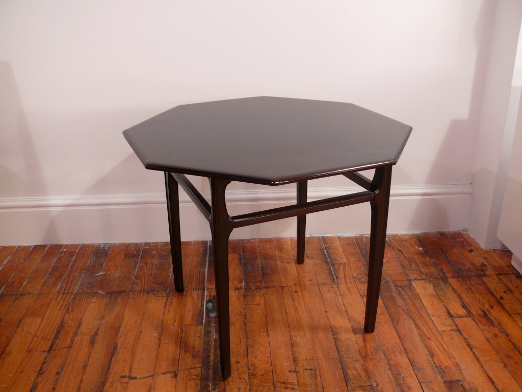 Elegant octagon side table with beautiful visible grain on the top. The sides have sculpted stretchers to add beauty and stability. Newly refinished in a rich dark chocolate finish.