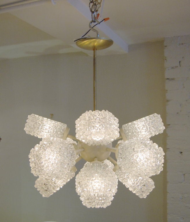 Fabulous 12 arm chandelier. Will make a major statement in all decors!

The 12 glass covers throw a fantastic array of light, each can be rotated a full 360 degrees for any arrangement of symmetric or random orientation.

Body of the chandelier
