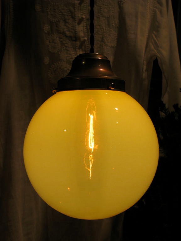 Beautiful Oversized Vaseline Glass Globe
Pendant light casts a warm glow and can be used depending on bulb wattage as task light, decorative or utilitarian applications
Newly rewired with antique brass fitter and black braided cloth cord. 
Custom