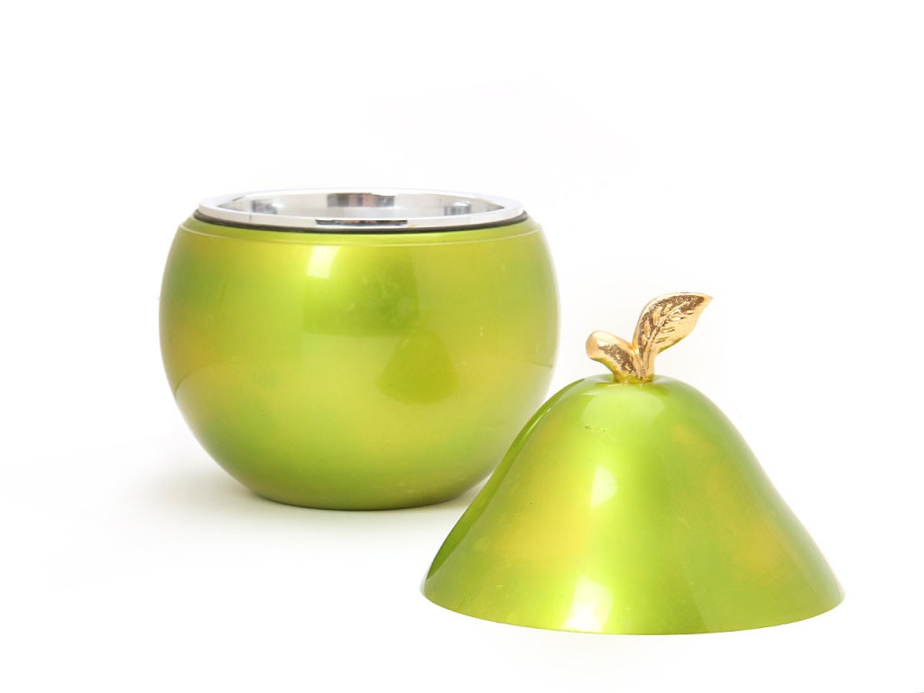 An ice bucket in the form of a metallic green pear with gold accent stem.