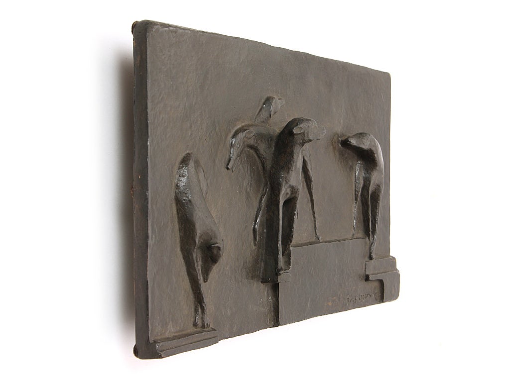 A rectangular patinated bronze relief plaque depicting greyhounds.