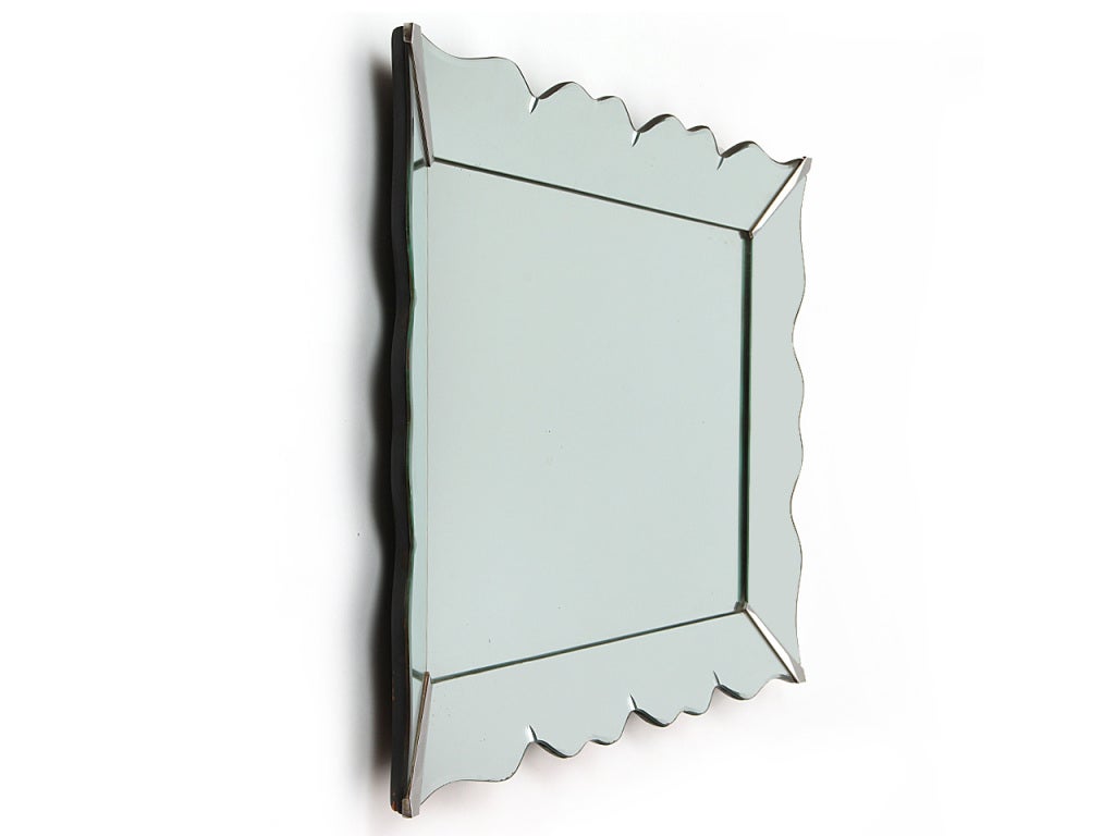 A rectangular wall mirror with mirrored frame and small embedded accents.