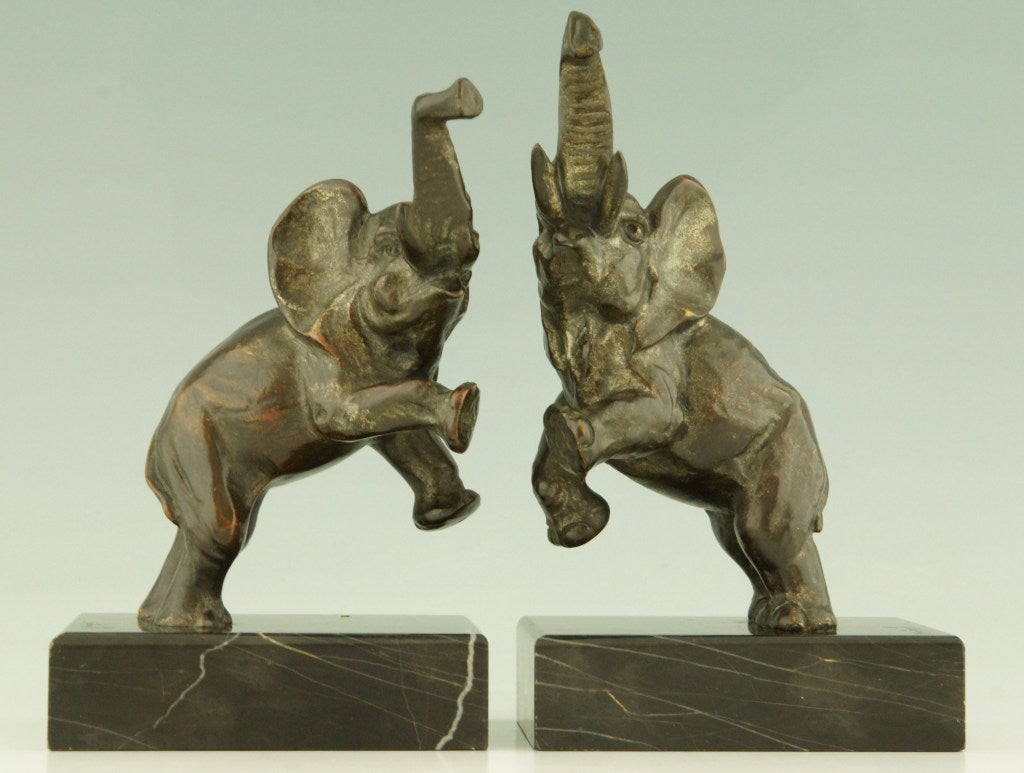 Fedex shipping: $ 165

A pair of bronze elephant bookends by Jean de la Fontinelle on portor marble bases. 

Literature:
”Craquelés” by Patrick Malaureille, Massin Editeur. 
“Dictionnaire des peintres, sculpteurs, dessinateurs et graveurs” by