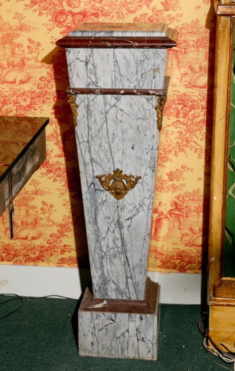 A single marble pedestal in two colors - gray and Burgundy