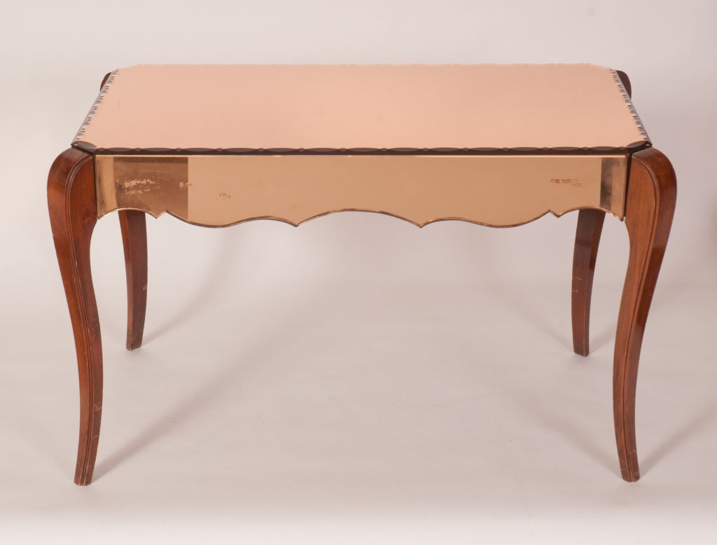 Very pretty, very feminine side table made of rose gold mirror with etching with wood legs.