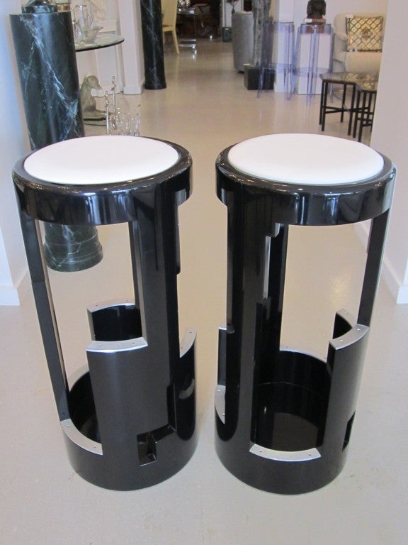 Pair of black Deco style bar stools with geometric profile and aluminum details.