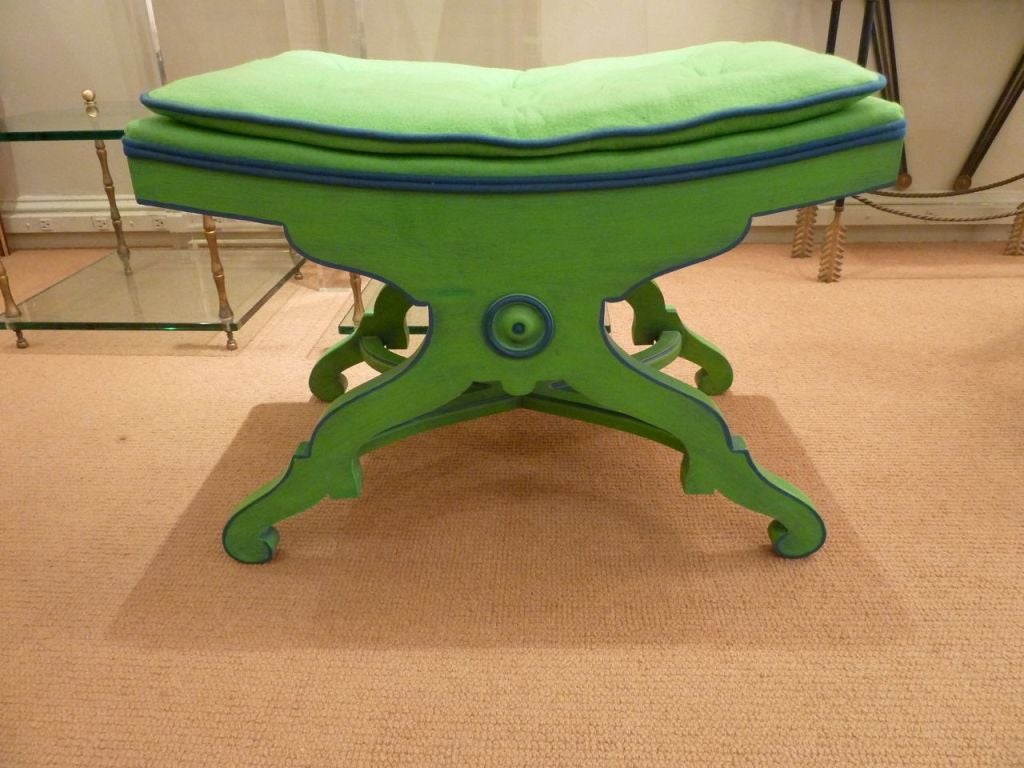 Charming pair of benches painted a vibrant kelly green with royal blue accents.  Curule-style frame is highlighted by curved x stretcher and scrolled feet. Coordinating original upholstery in wool flannel, with 6 tufting points and contrasting