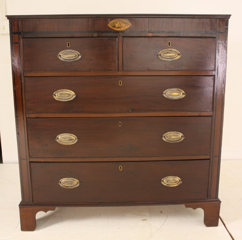 Antique mahogany chest of drawers from England with a lovely marquetry shell inlay, with a rich color and very nice patina. This elegant bureau also has ebony stringing on the frieze and sides. Very early piece has replaced handles and feet.