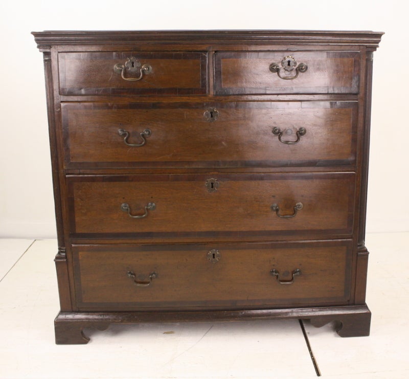 An early chest of drawers from Wales. This antique oak bureau has a deep rich color and has rich mahogany crossbanding. Note the fine reeded quarter-columns. Reduced, NT.