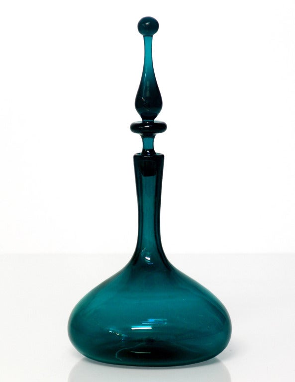 ______

(Items also available individually, please email to inquire.)

LEFT: decanter with elaborate finial stopper and ship's decanter base, designed by Joel Philip Myers in 1965. Design #6516 in Peacock, pictured in the 1965 catalog.
Measures