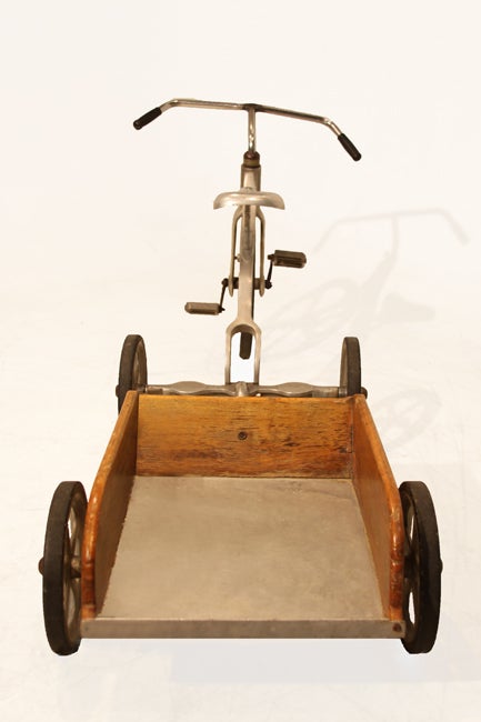 A vintage solid aluminium tricycle with an attached wooden cart. The handlebars have been welded and it is very good riding condition, even for an adult to use. Distressed, vintage condition reflects in the patina and in the charming signs of age