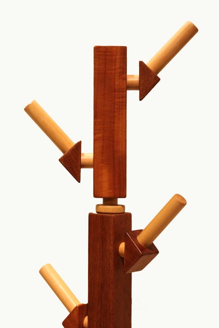 A Pau Marfim, Ipe, and Vinhatico coat rack designed by Brazilian designers Rodrigo Calixto. Rack has ten pegs and is very sturdy on four geometric feet.

