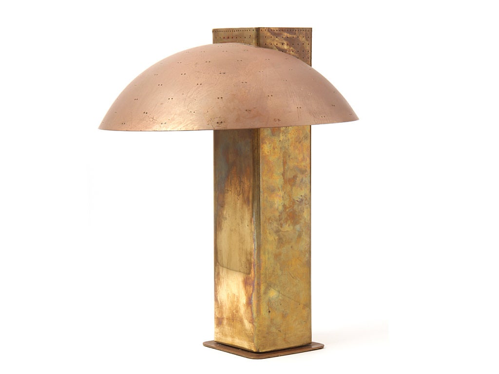 A brass desk lamp with a perforated shade for task lighting with two bulbs and a grid covered uplight with separate switch. Produced and stamped by TAITO.