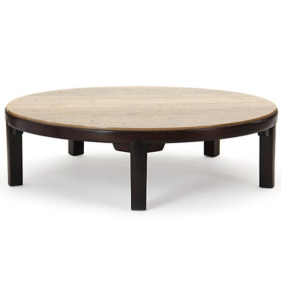 A round coffee table with travertine marble top on a ebonized, convex-faced mahogany base with 