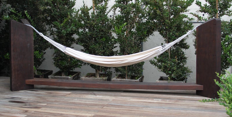 Massive solid Ipe wood hammock designed by Zanini de Zanine. Made from solid reclaimed Ipe architectural beams. This piece was hand made in Zanini's workshop in the Sertaozinho favela in Rio De Janeiro. The techniques Zanini uses are time honored