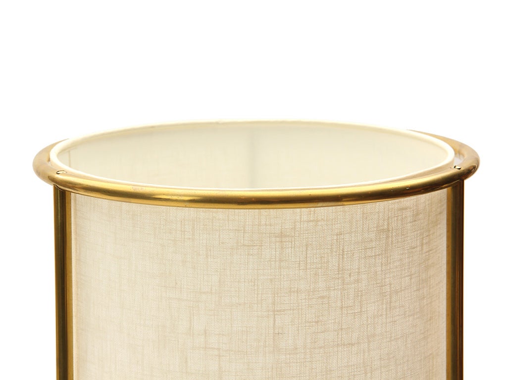 A floor lamp with a circular shade comprised of three brass stems and three brass rings. By T.H. Robsjohn-Gibbings  for Hansen.  Shade is 19
