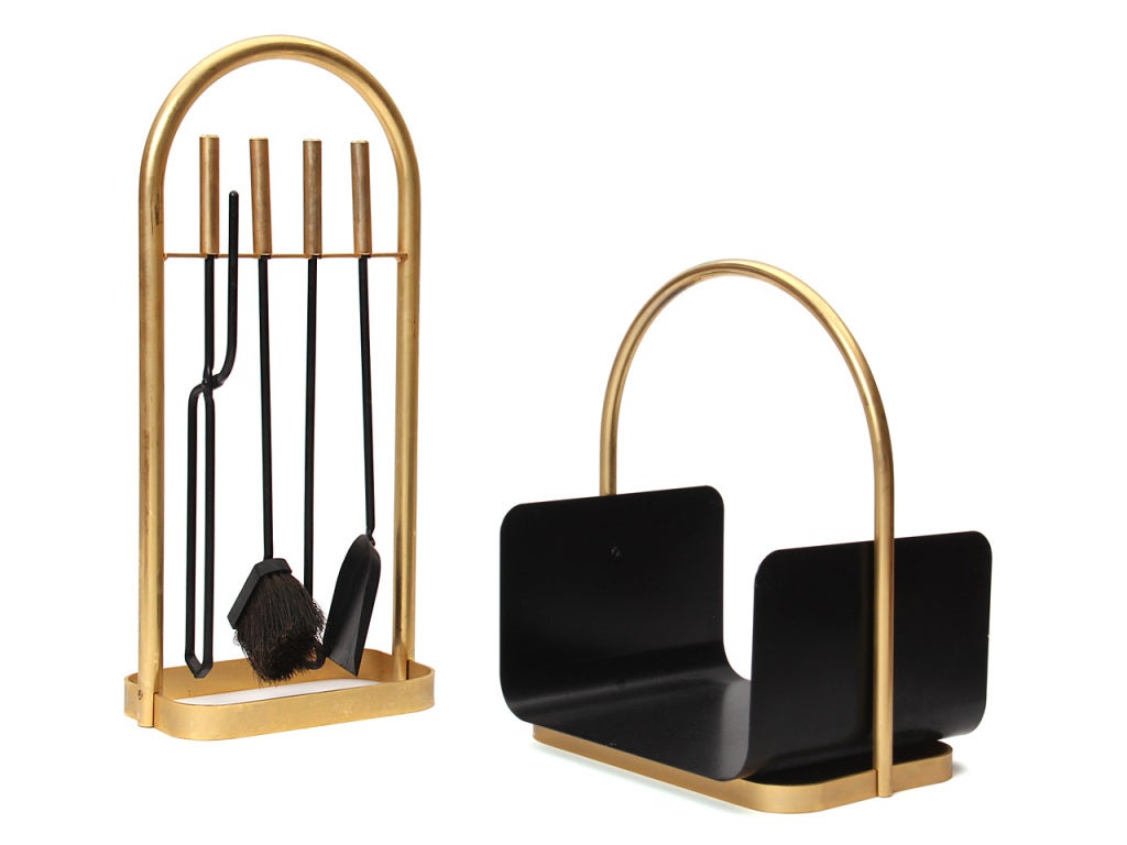 A set of fireplace accessories which includes a log basket with a brass base and bent brass rod handle and a set of four fire tools in a bent brass rod organizer.