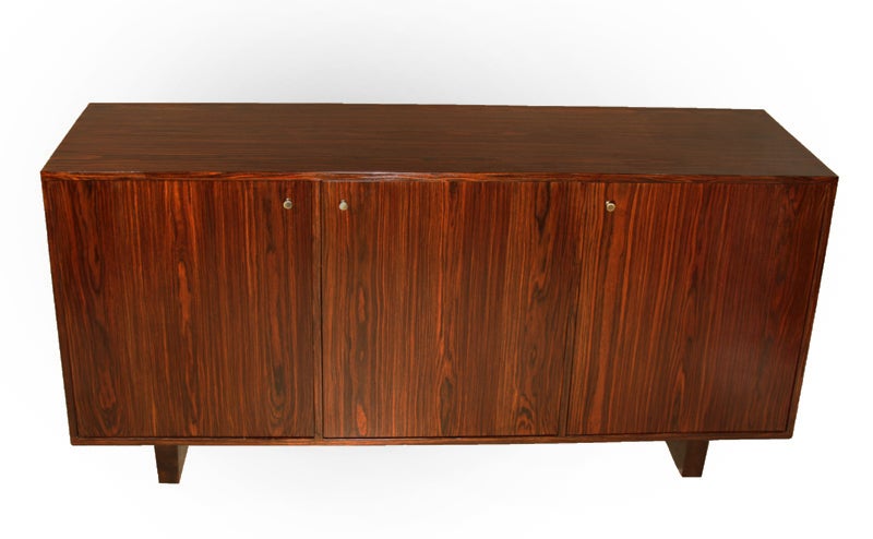 A stunning rosewood credenza with solid wood base and polished brass hardware. Doors open to shelving and ample storage space.

Many pieces are stored in our warehouse, so please click “Contact Dealer” button under our logo to find out if the