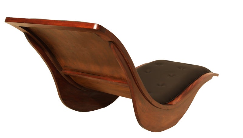 This is a swooping rocking chaise lounge composed of exotic hardwood with a tufted black leather seat by Brazilian designer Igor Rodriguez. The design is sleek and incredibly comfortable.

Many pieces are stored in our warehouse, so please contact