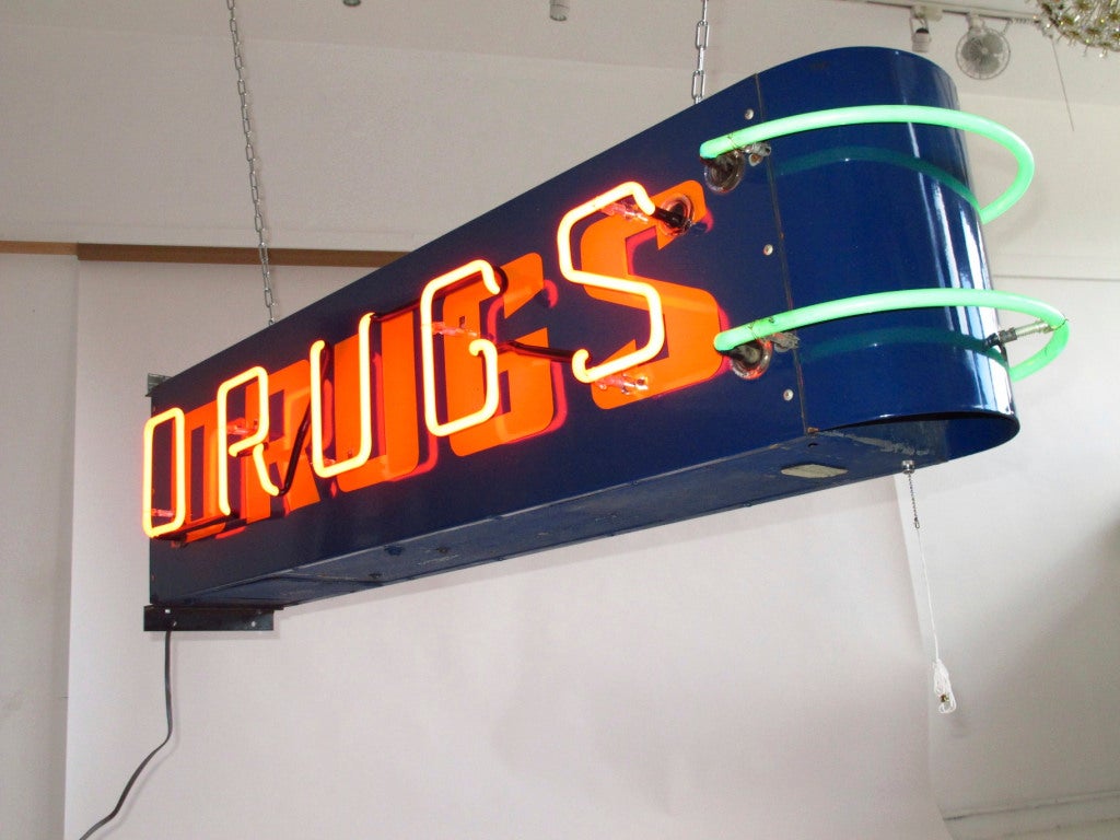 1940's neon drugs store sign. Newly restored. Original enameled finish. Neon in excellent condition. New transformer and switch. Easily mounts to a wall.