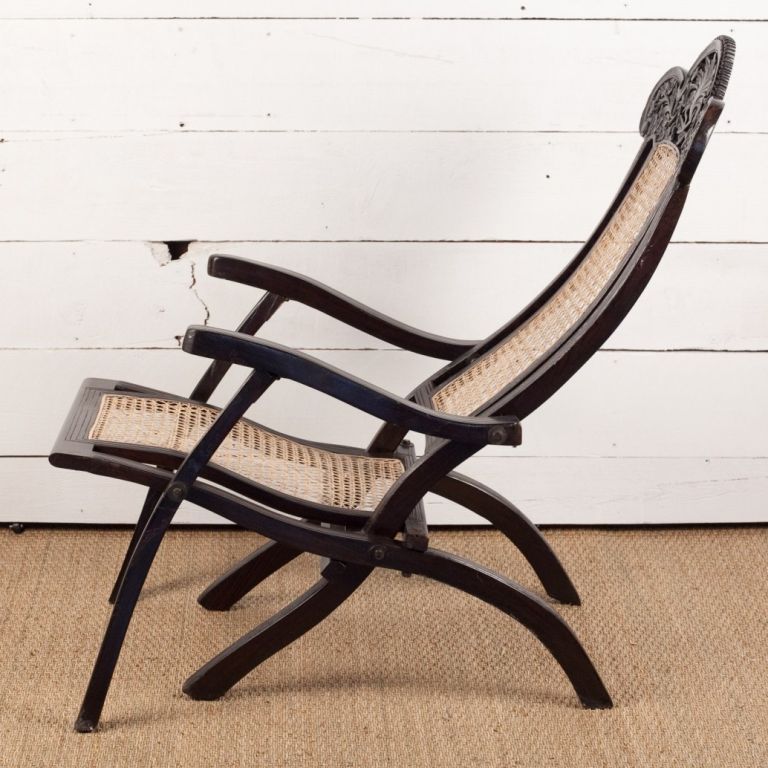 Indo-Portuguese folding chair in solid rosewood with caned seat and carved top rail. Very comfortable lounge or deck chair.