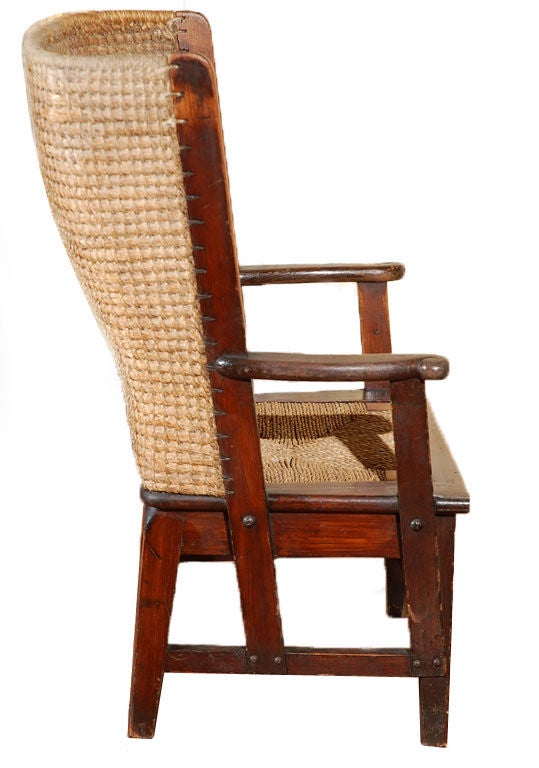 Mid-19th century American antique oak children's Fireplace chair with woven rush seat. This chair was most probably a salesman's sample or a custom version of this wingback gem.