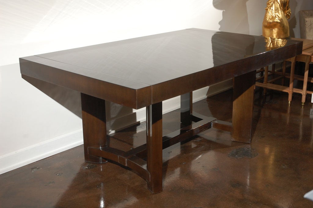 Handsome Widdicomb dining table with two leaves, in a lovely high polished ebony finish.