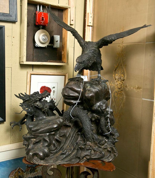 A bronze statue symbolizing the battle of World War II.  An American eagle fighting a Japanese dragon.  Made of bronze and a symbol of victory and triumph.  Perfect statue for The Patriot Flight of American Pride.