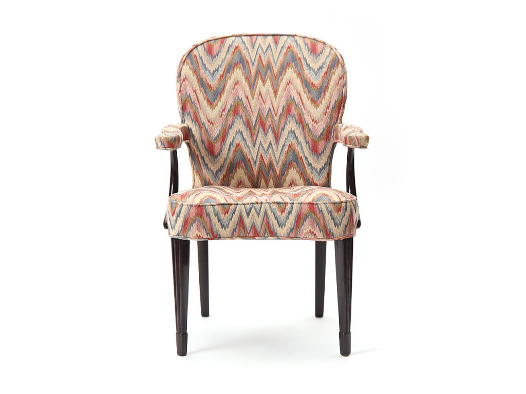 A pair of upholstered armchairs fluted with dark fluted mahogany legs and 