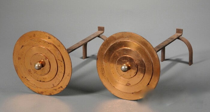 A pair of graphic and sculptural  Art Deco/Machine Age circular copper stepped disc andirons with brass ball centers and wrought iron supports.