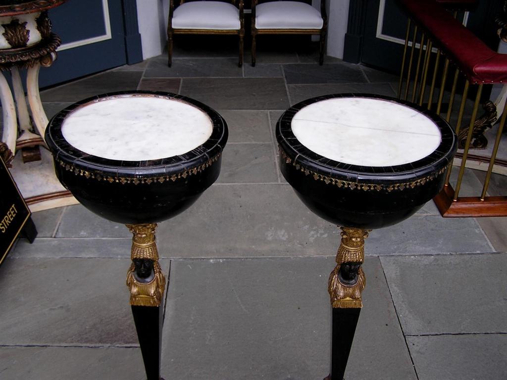 Pair of Russian Gilt figural and ebonized marble top pedestals terminating on tripod winged hoof feet. Late 18th Century