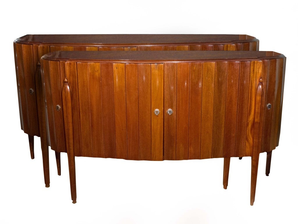 # W501 - PAIR of French Art Deco side cabinet after designs by 
EMILE-JACQUES RUHLMANN (1879-1933). The molded bow fronted top above a wave fluted frieze with four doors. All raised on short round tapered legs decoratively treated at the top of