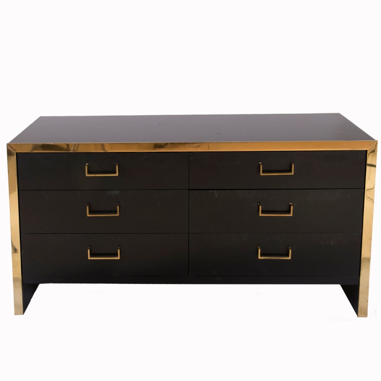 Ebonized wood and brass trimmed dresser.  Six drawers with glides and brass drawer pulls.  Similar to a John Stuart design.