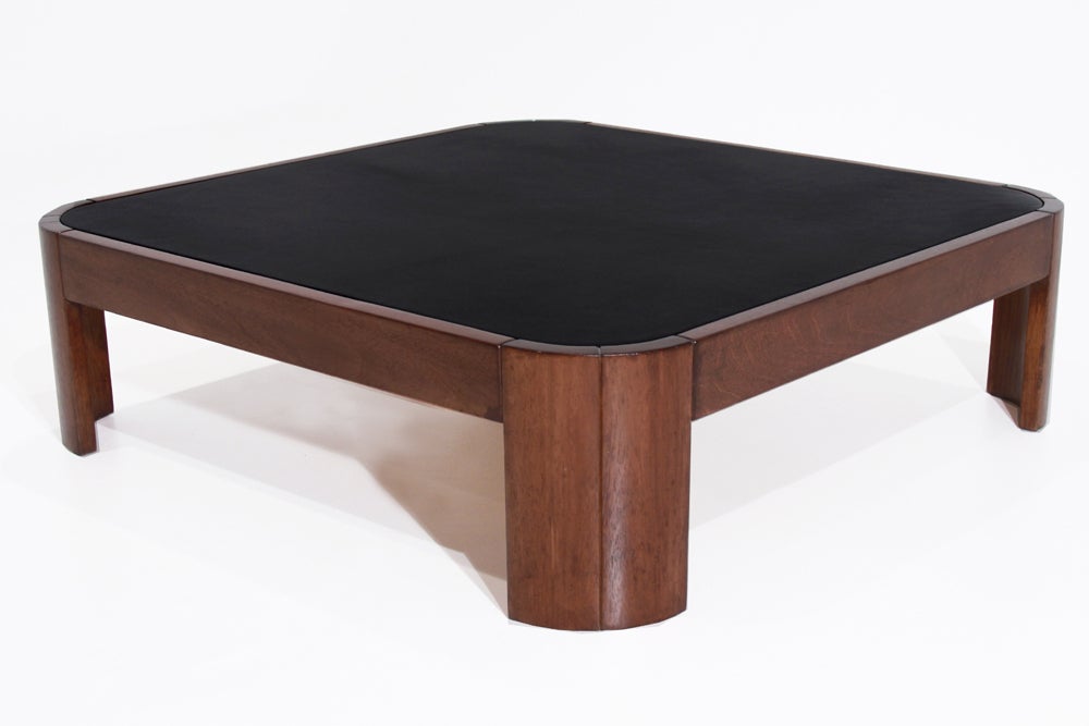 Square exotic wood coffee table with inset black leather top from Brazil. Wood has rustic qualities as shown in the photos but has been refinished nicely, and the curved corners add interest to a simple design. A matching larger rectangular coffee