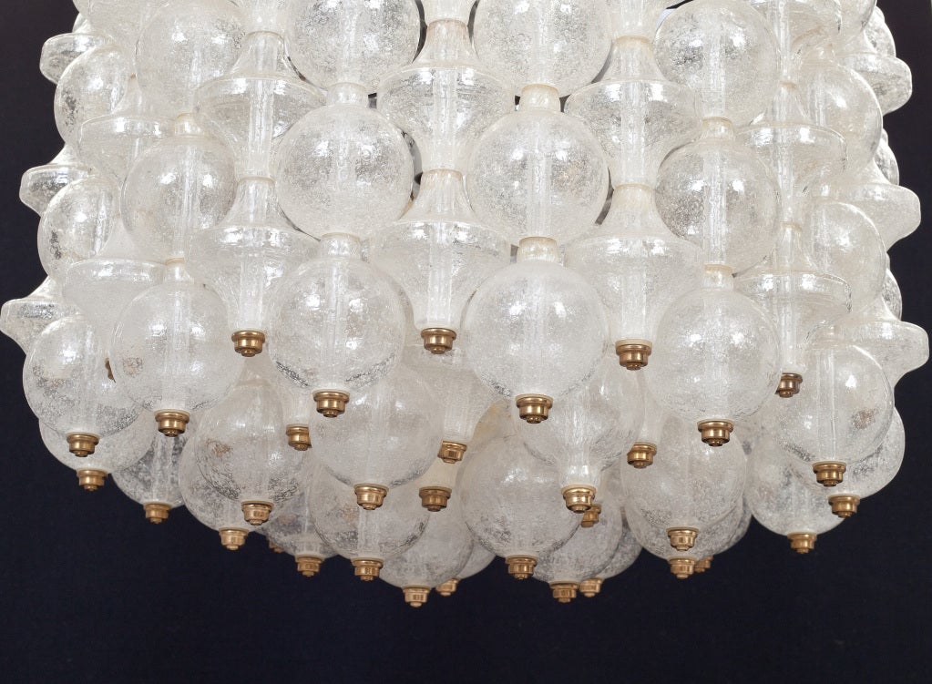 An interlocking glass chandelier with brass hardware.

Italian, Circa 1960's
