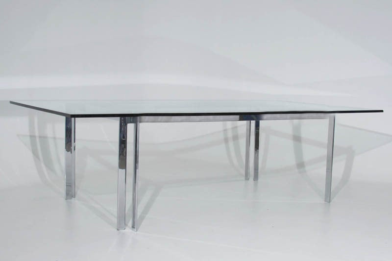 The table base is made of solid chromed steel. The legs slip together and the large glass top sits sturdily upon them.

 