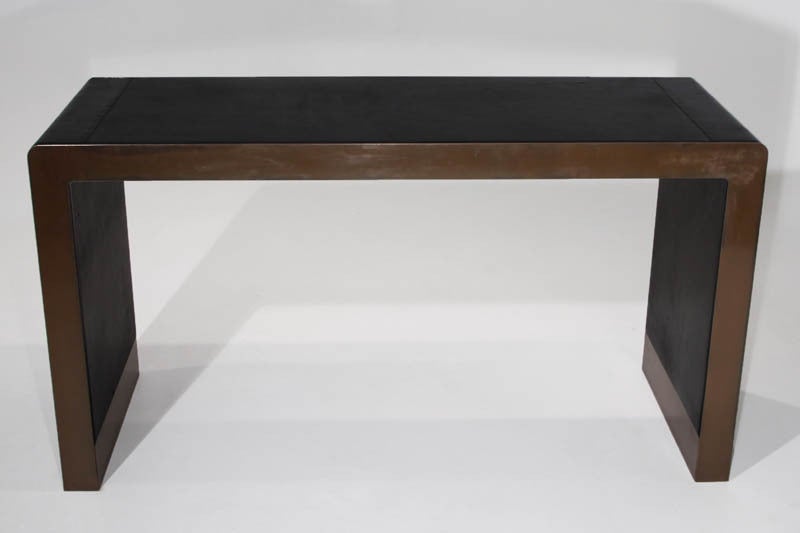 Inset distressed black leather and bronzed chrome desk or console table.
Many pieces are stored in our warehouse, so please give us a call at (323) 463-4434 or email us at info@thomashayesgallery.com to find out if the pieces you are interested in