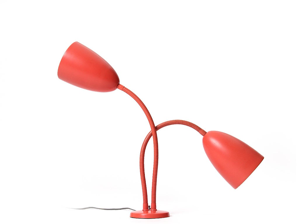 A steel desk lamp with two (2) articulating steel gooseneck arms in the original salmon color.