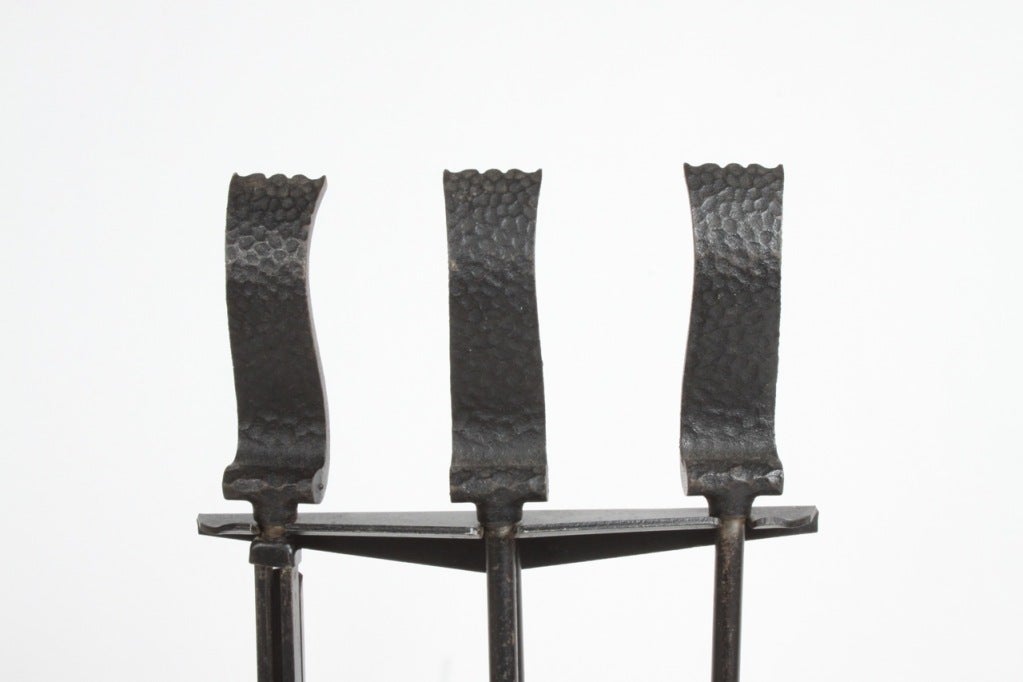 Scroll handles fire tools in textured iron, stand with tripod base, designed by Donald Deskey for Bennett, circa 1950.