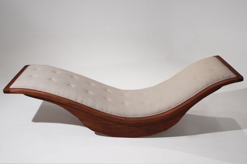 This is a swooping rocking chaise lounge composed of exotic hardwood with a tufted coarse linen seat by Brazilian designer Igor Rodriguez. The design is sleek and incredibly comfortable.

Many pieces are stored in our warehouse, so please click on