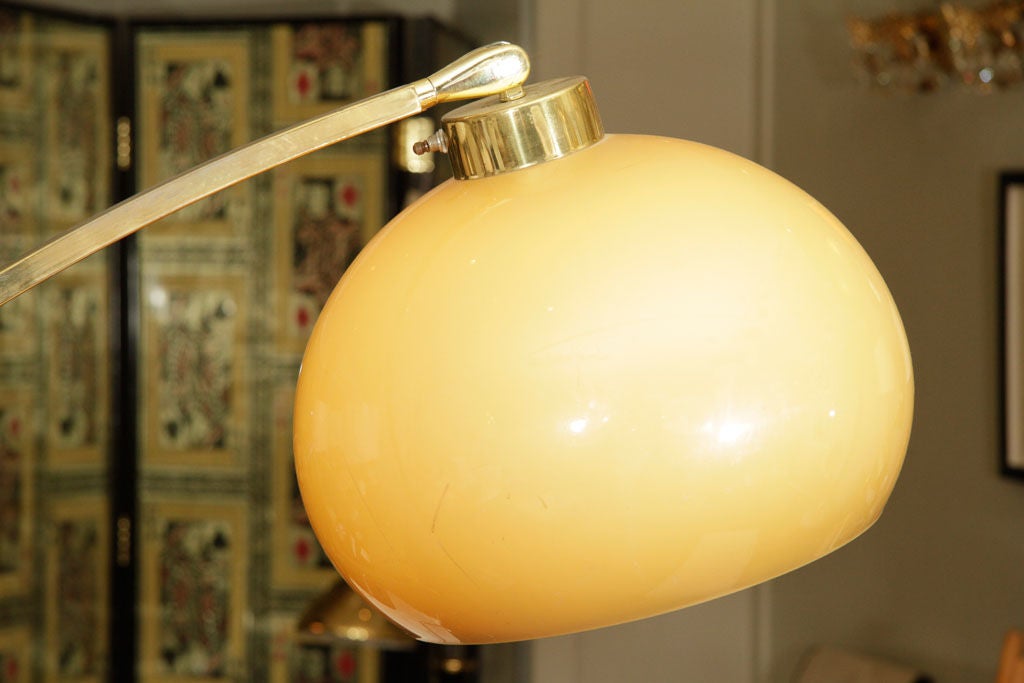 Cool mod arc lamp with rectangular wedged marble base.  Arc is brass with teak support.  Globe is molded plastic in a muted ochre hue.<br />
Stand 13