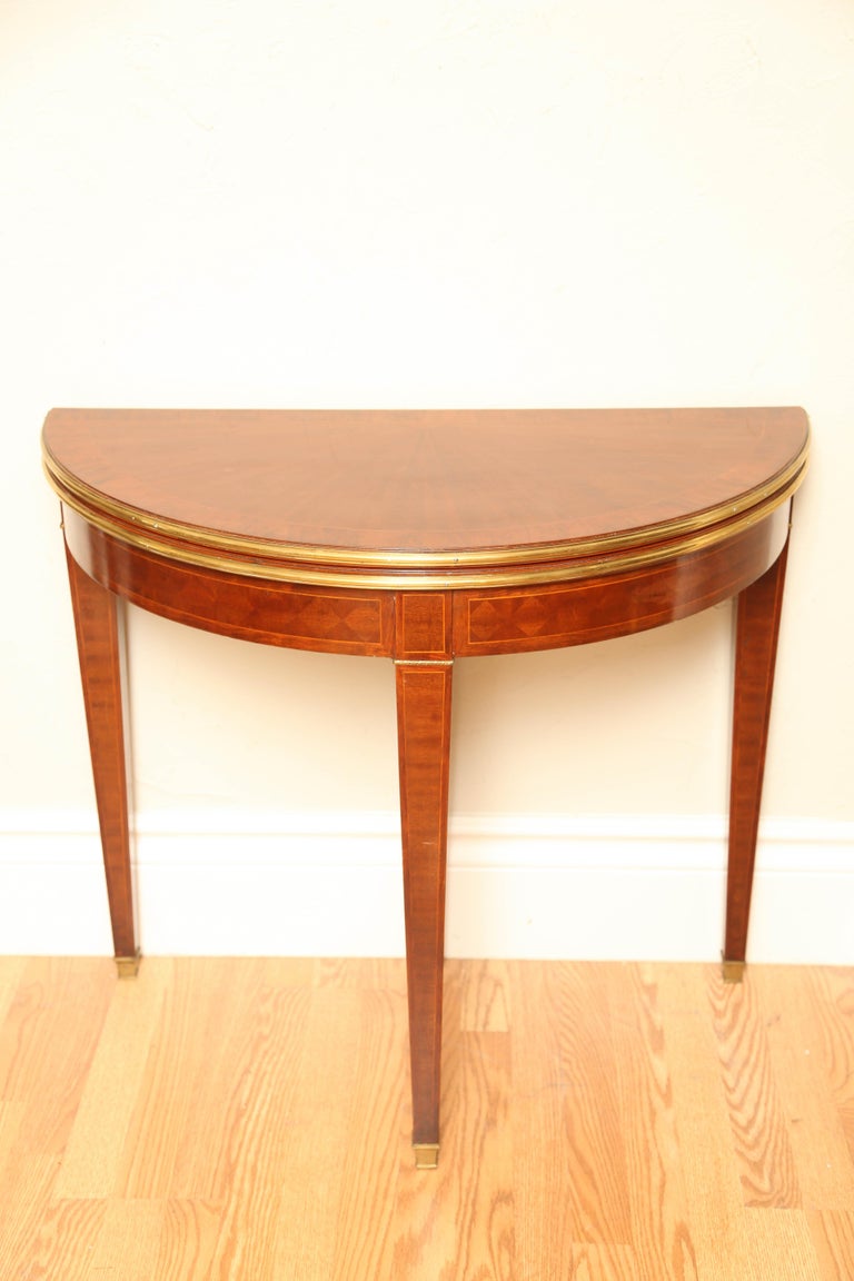 Antique french demilune card table or console with embossed leather top opens to a 35